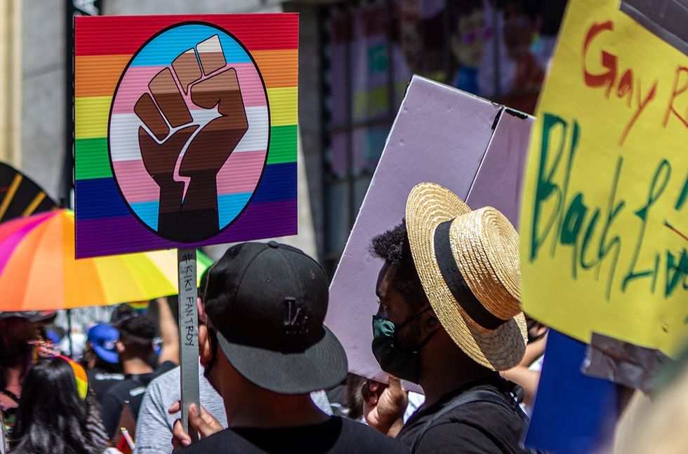 2020 Protester holding a rainbow LGBTQIA pride flag fist sign at the Black Lives Matter march in Hollywood California