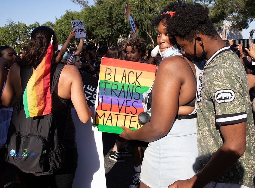 2020 Protester holding a rainbow LGBTQIA pride sign at the Black Lives Matter march in Hollywood California