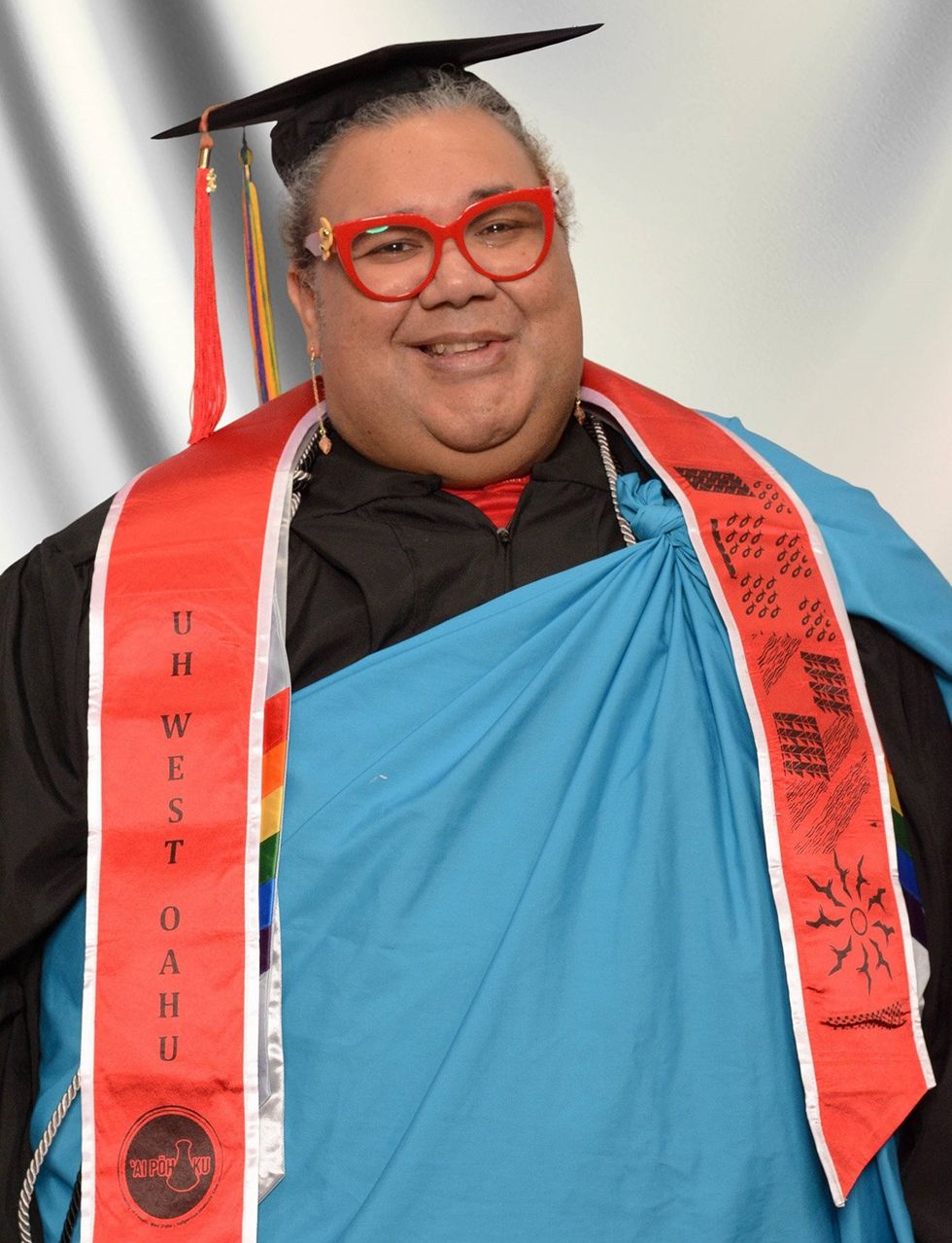 2025 Point Foundation Scholar Graduate Kawena Lornezo graduation cap and gown with sash