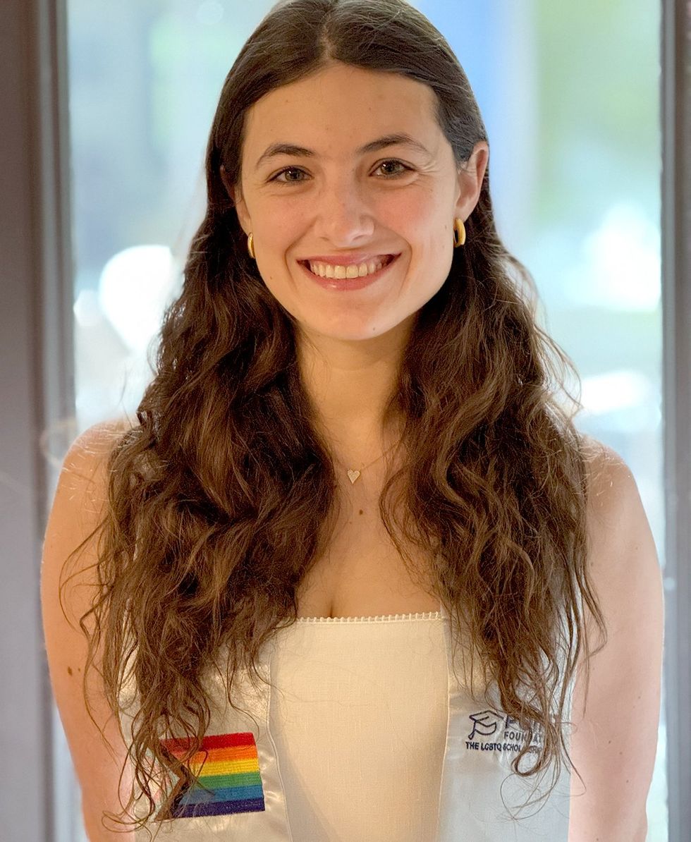 2025 Point Foundation Scholar Graduate Sofia Arlen wearing LGBTQIA rainbow flag Point Foundation graduation sash
