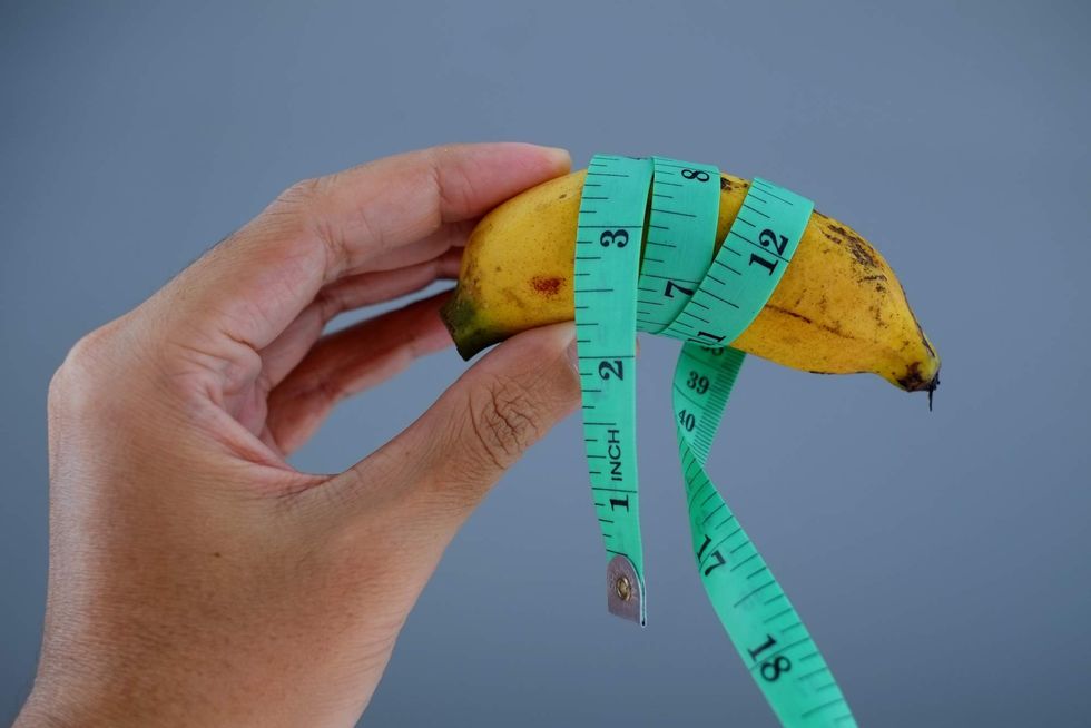 A banana wrapped in a measuring tape.