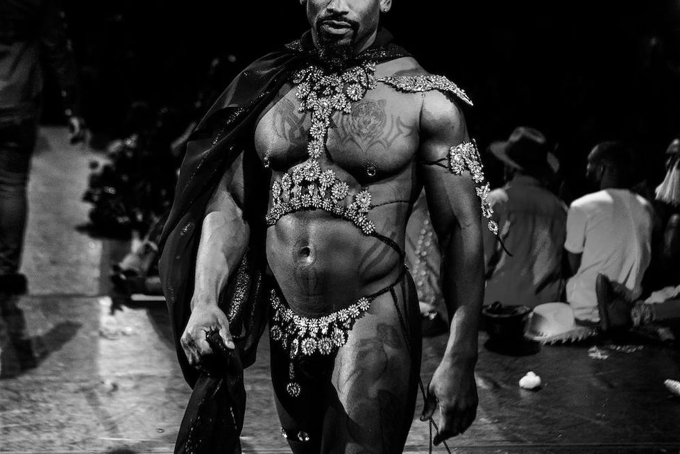 A black and white photo of a muscular man's torso.