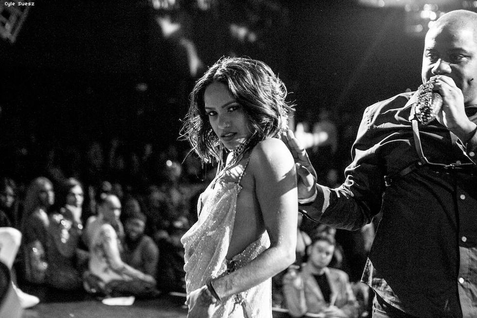 A black and white photo of woman walking the sex siren category at the Miyake Mugler ball.