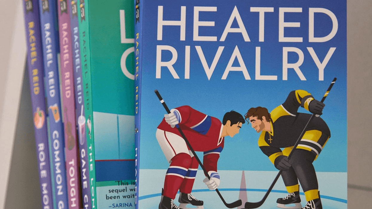 A close-up of the illustrated cover of Heated Rivalry by Rachel Reid