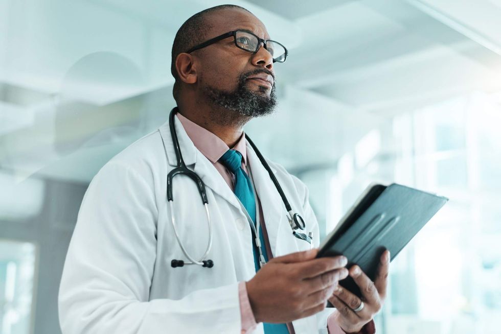 A doctor holding a clipboard
