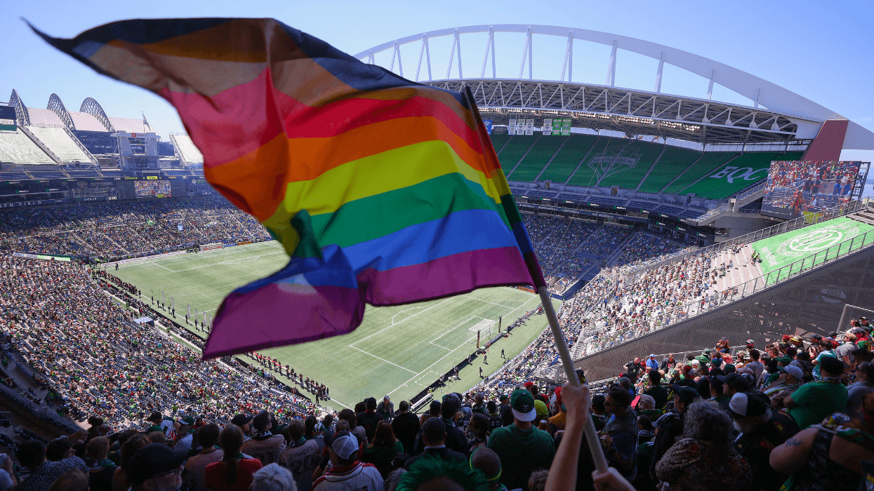 A fan waves a Pride flag before the game between the Seattle Sounders and the Portland Timbers at Lumen Field on June 03, 2023 in Seattle, Washington.