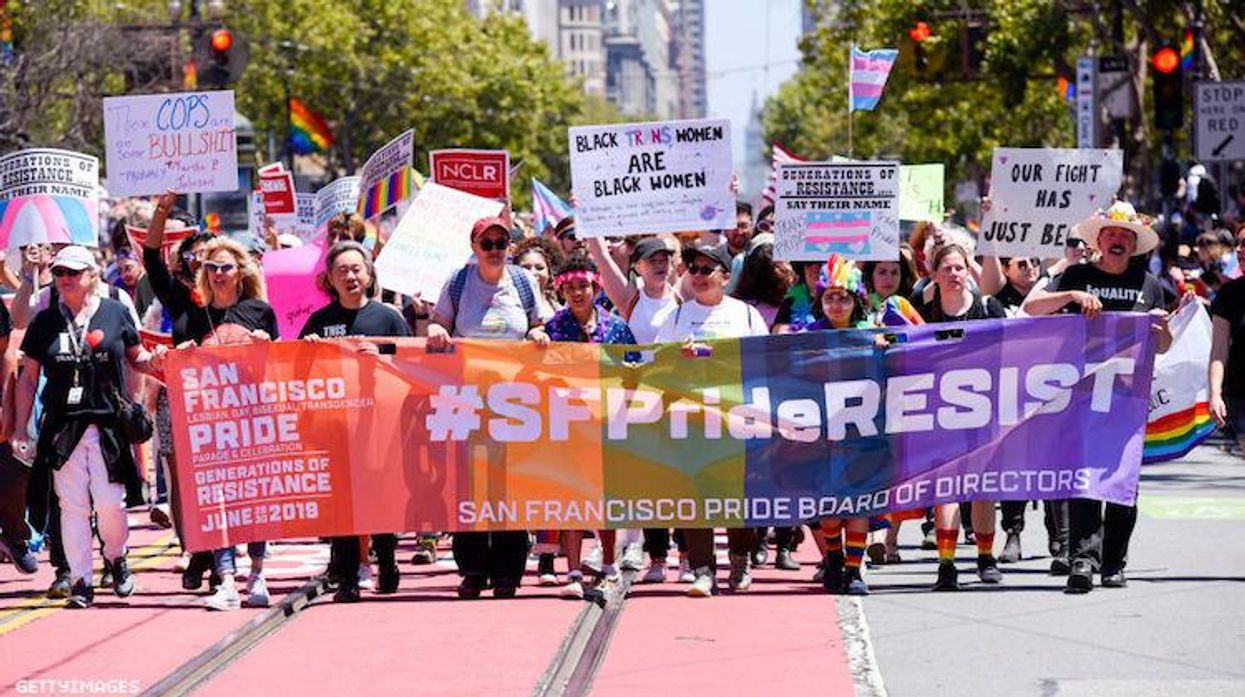 A group of people with a flag at San Francisco Pride.