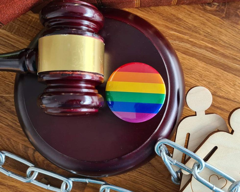 a judge's gavel and rainbow pin