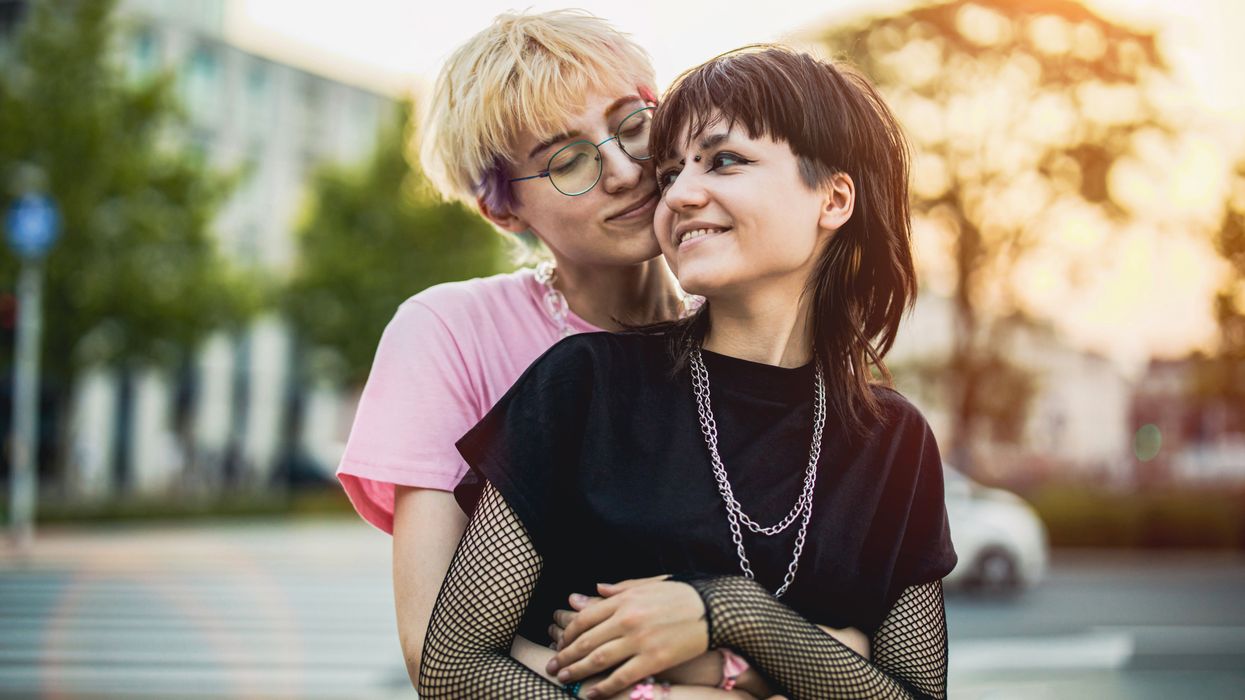 a lesbian hugging another lesbian from behind