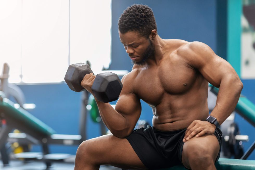 A man doing bicep curls at the gym