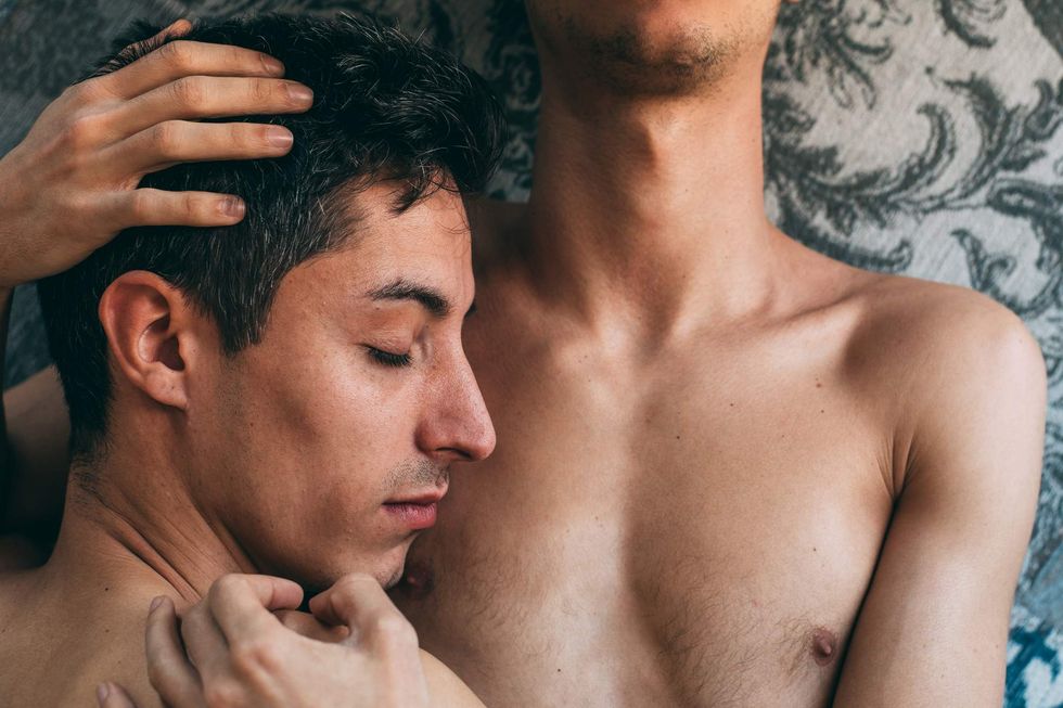 A man holding another man to his chest