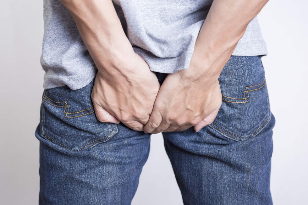 A man holding his butt