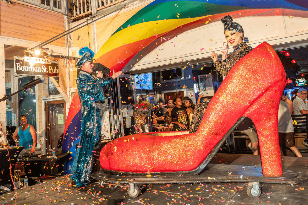 A performer and the event's host pose onstage during the 2026 If the Shoe Fits national finals in Key West.