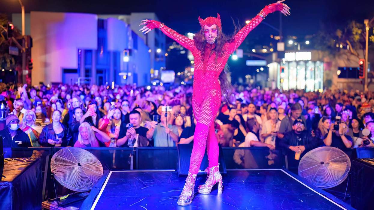 A performer in a red devil costume at the 2025 West Hollywood Halloween Carnaval.