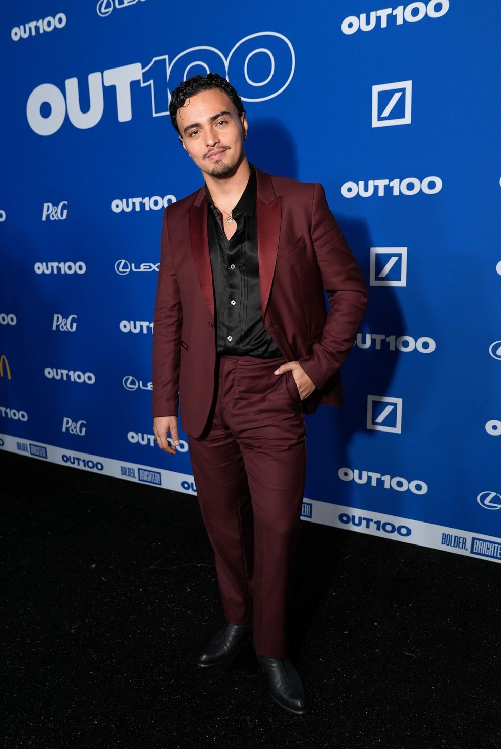 A person posing on a red carpet
