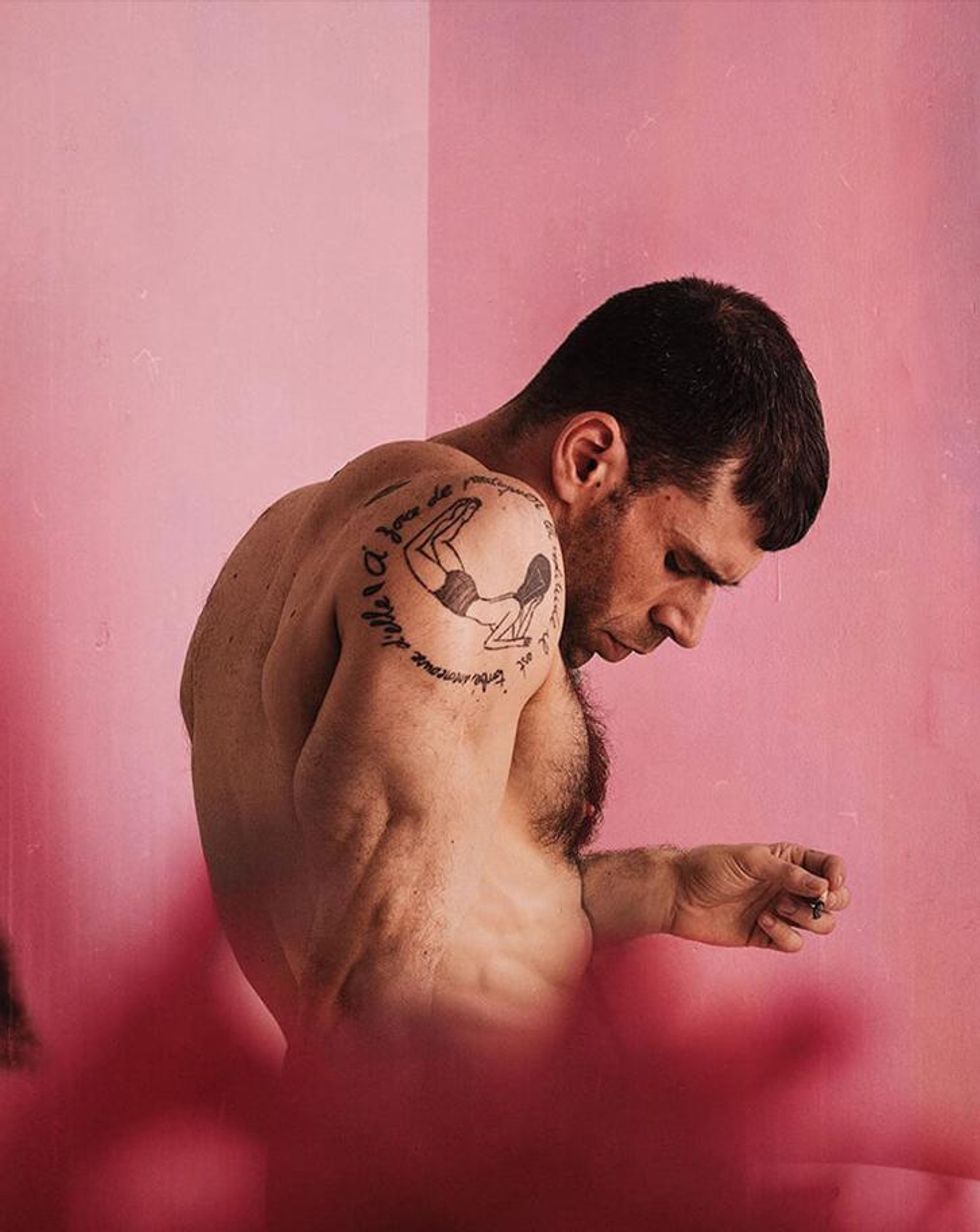 A photo of a tattooed model from behind.