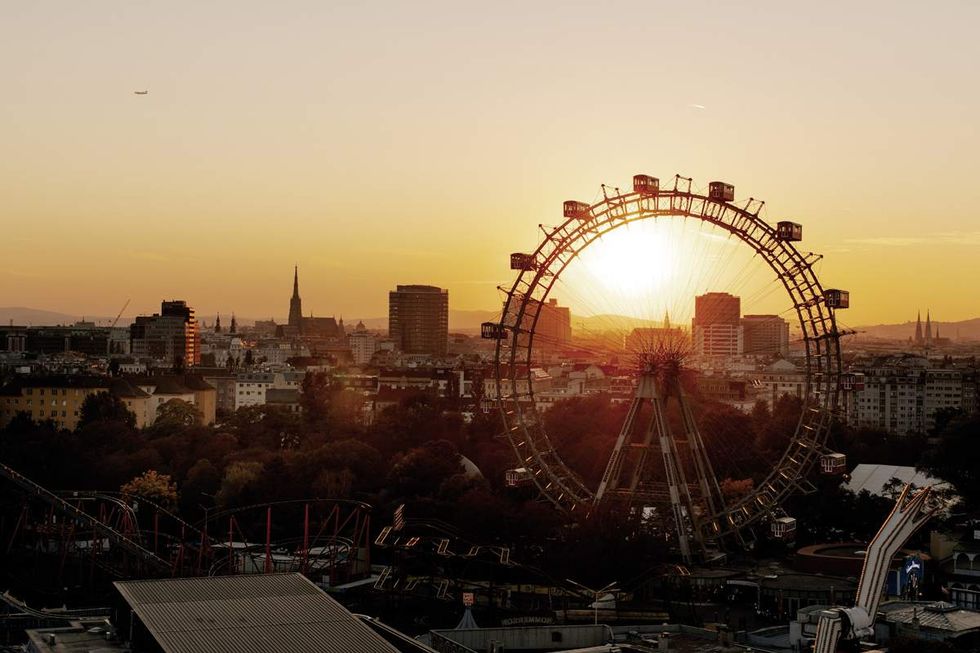 A photograph of Vienna at sunset featuring the giant ferris wheel