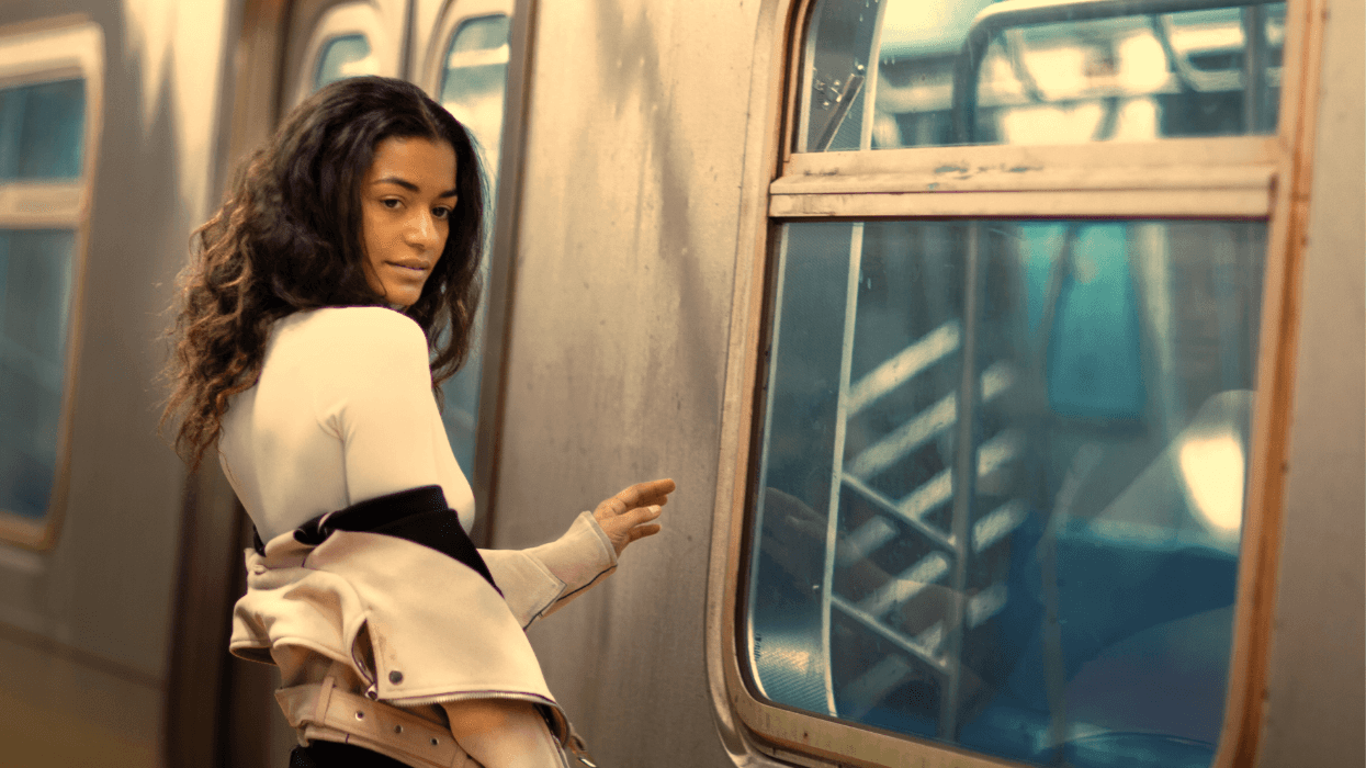 A woman turns slightly while boarding a subway train, suggesting a fleeting moment of recognition in a public space