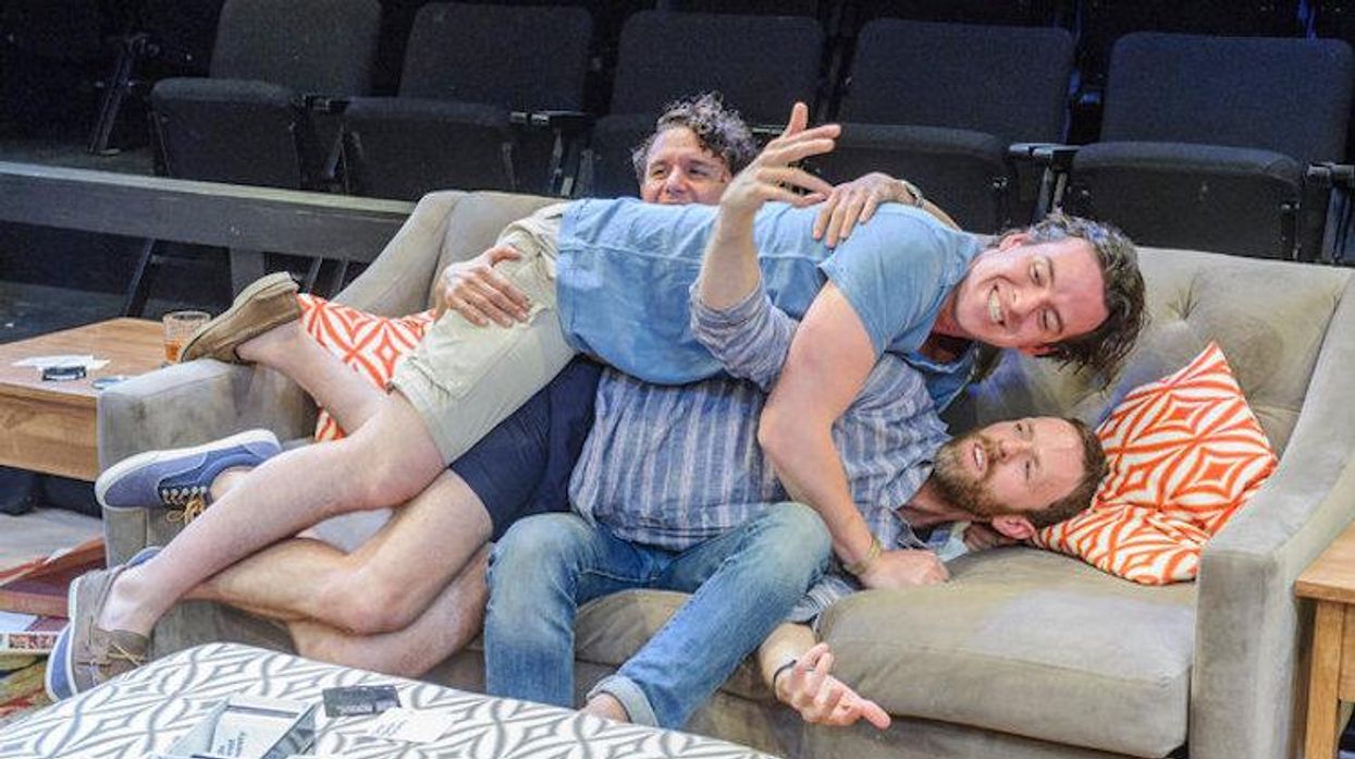 Aaron Rossini (seated), Jimmy King (below) and Craig Wesley Divino (on top) in “At the Table.”