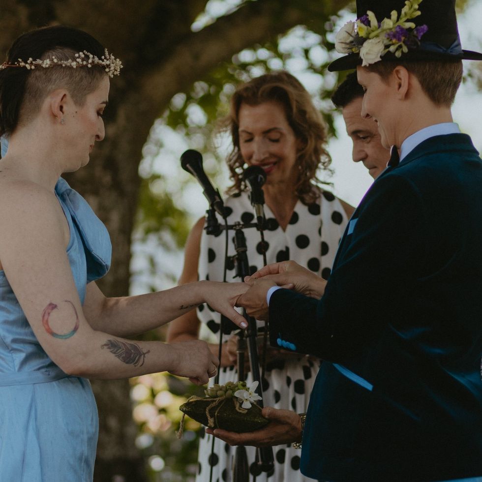 Alysia Reiner leads the couple in exchanging rings.