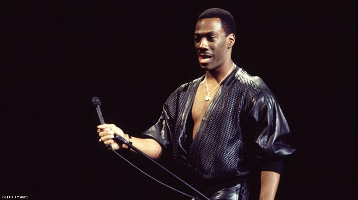 American comedian Eddie Murphy performs onstage at Madison Square Garden during his 'Raw Tour,' New York, New York, October 13, 1987. (Photo by Gary Gershoff/Getty Images)