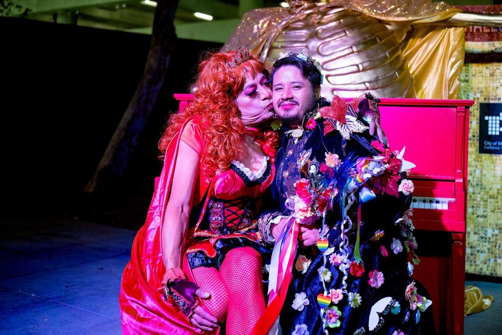 An attendee receives a kiss on the cheek at the 2025 Carnaval.