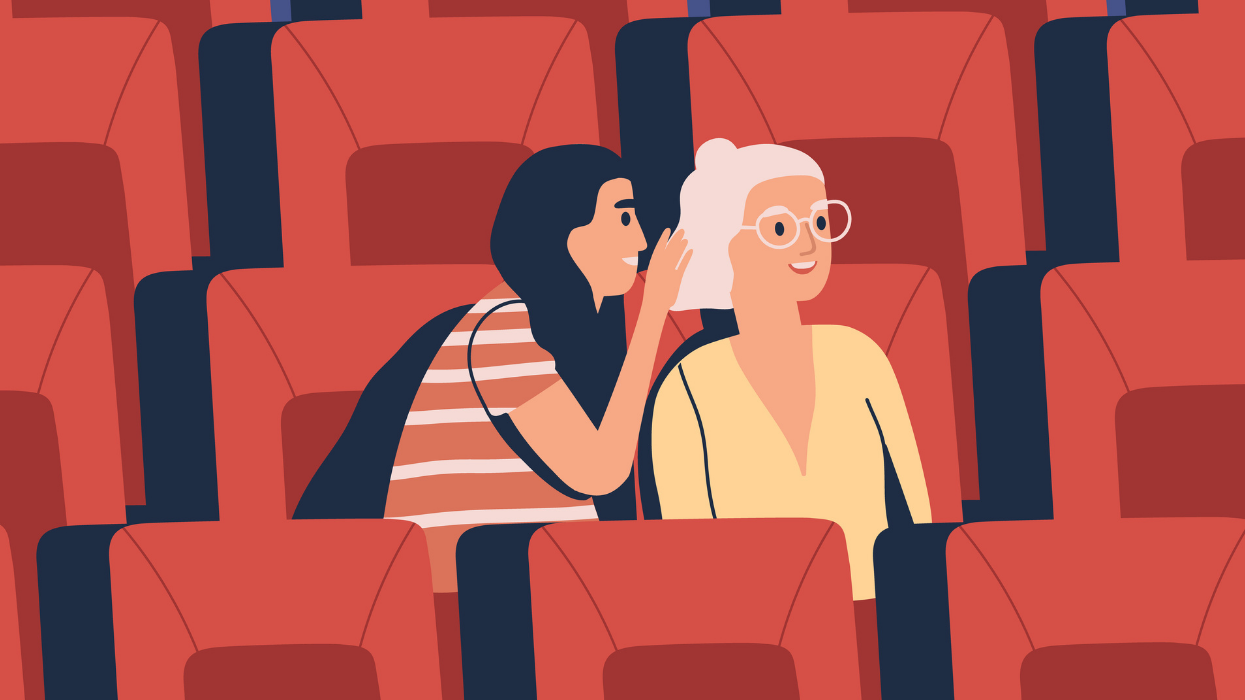 An illustration of one woman leaning over to whisper something in another woman's ear.