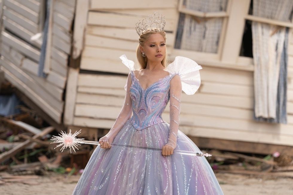 Ariana Grande, as Glinda, standing in front of Dorothy Gale's house in Wicked: For Good