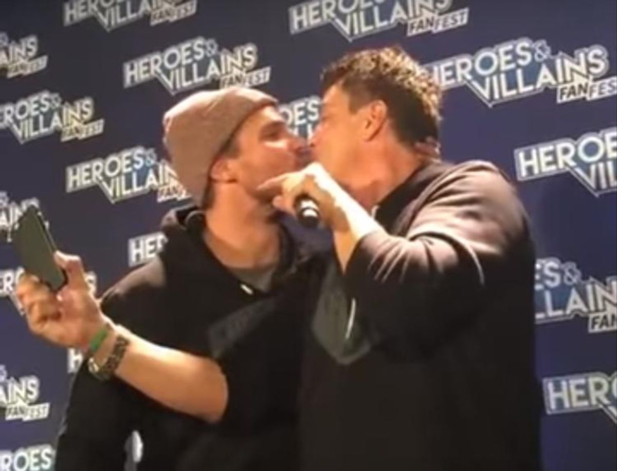Arrow stars Amell and Barrowman kiss.