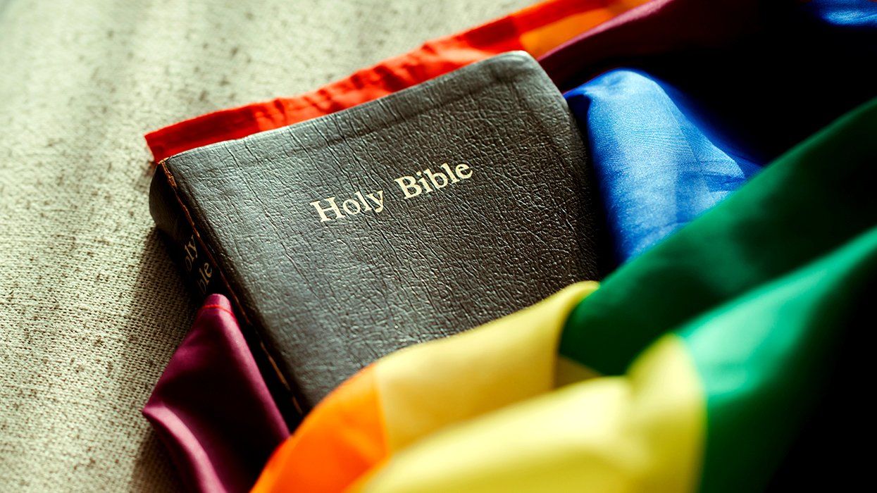 black book holy bible wrapped in rainbow LGBTQIA pride flag