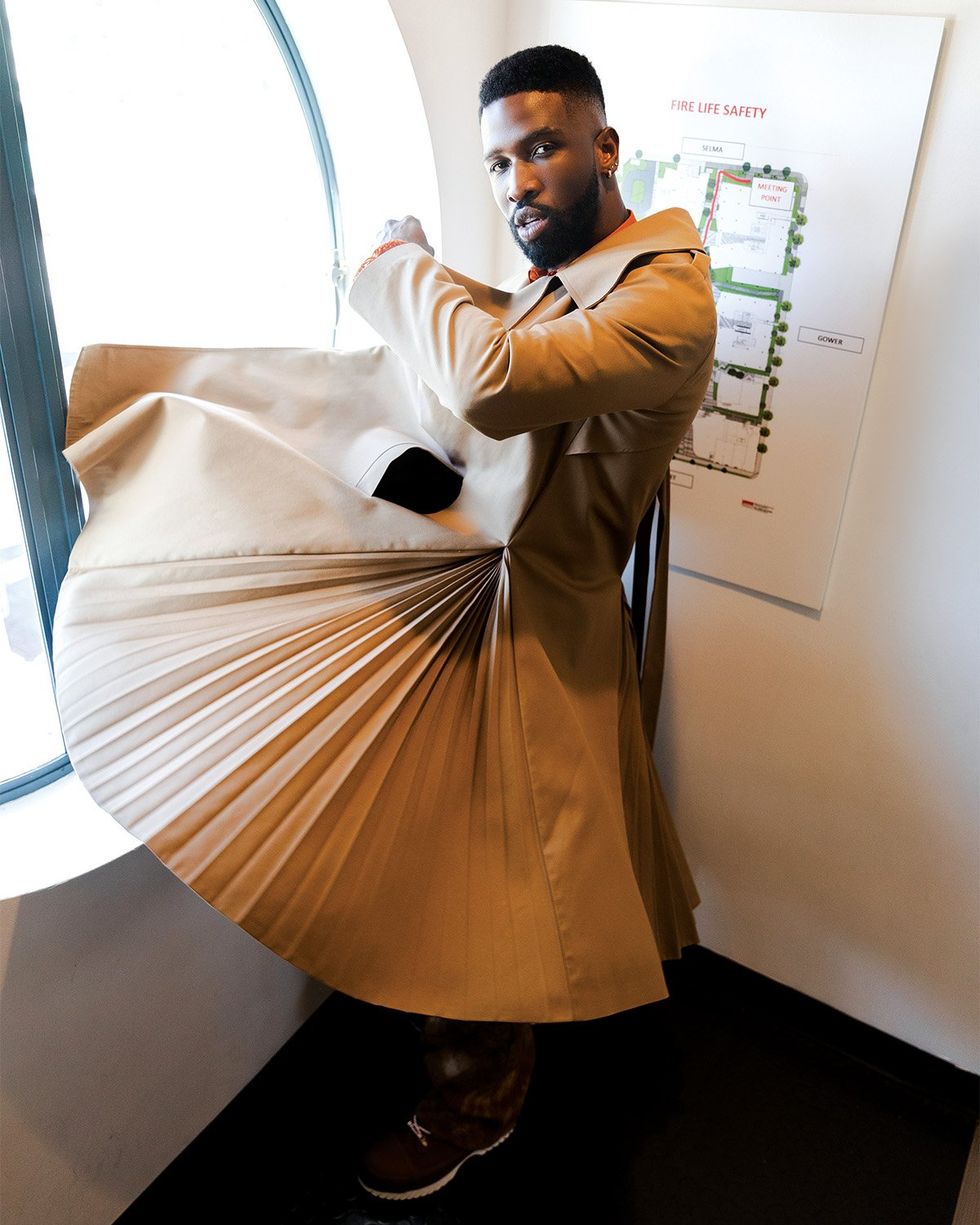 BRANDON in WEISHENG PARIS Coat; PIERRE BLANC Sweater and Shirt; COSMIC COLLECTIVE Pants; CONVERSE Boots