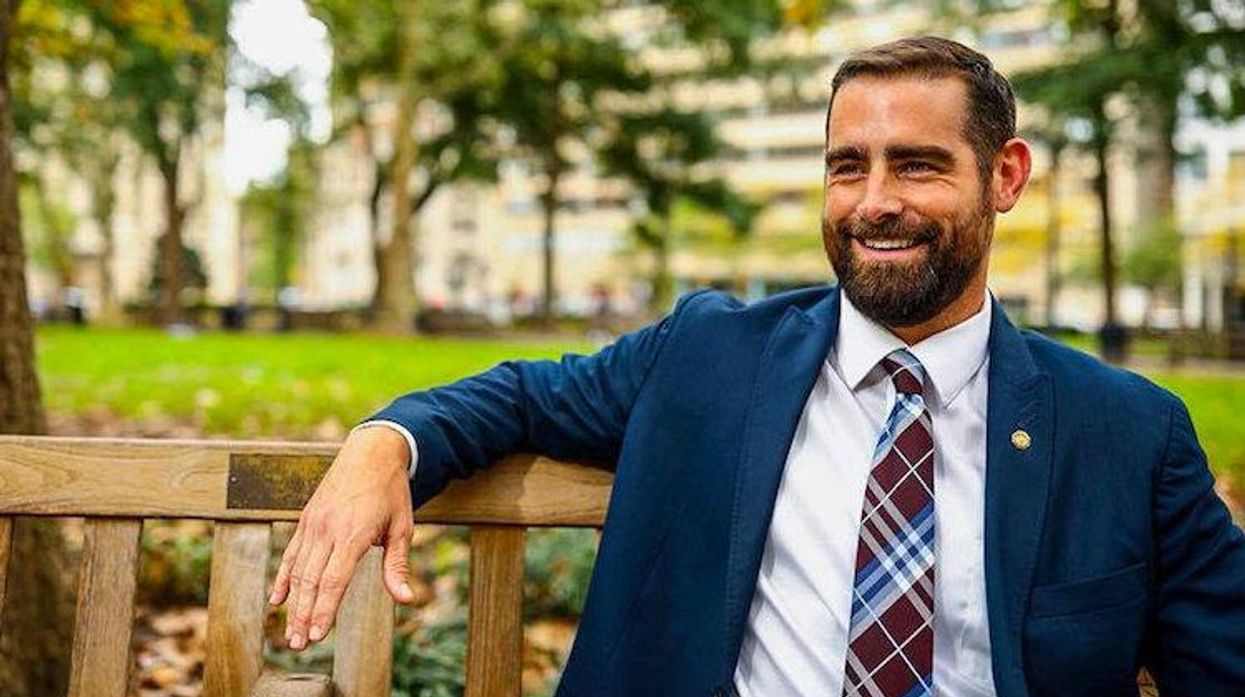 Brian Sms sitting on a bench.