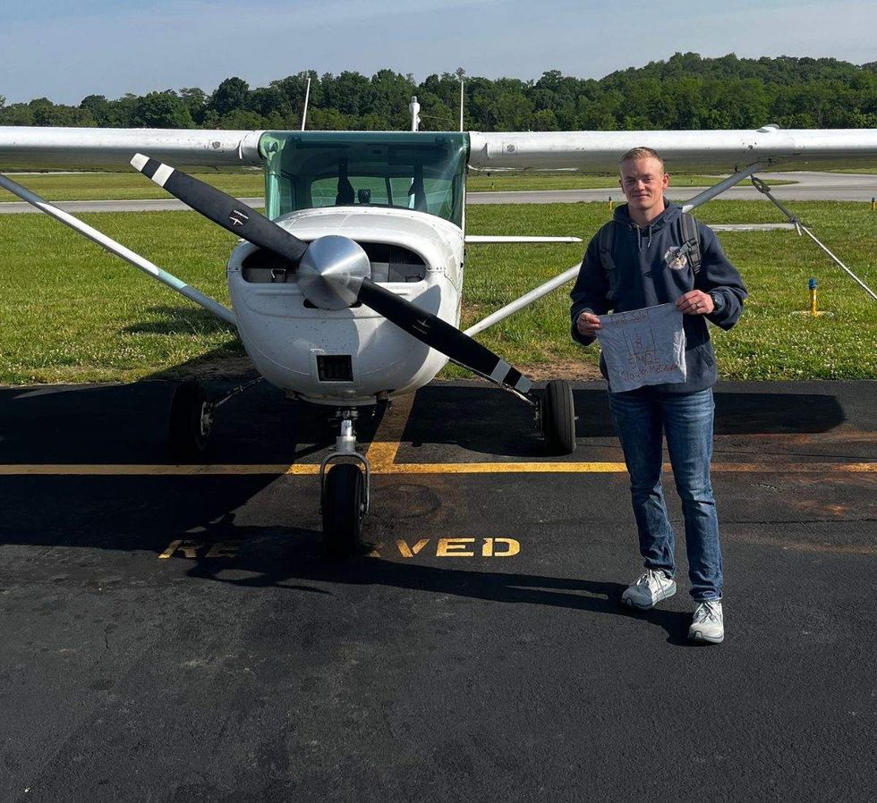 clayton mccallister standing next to a single engine airplane