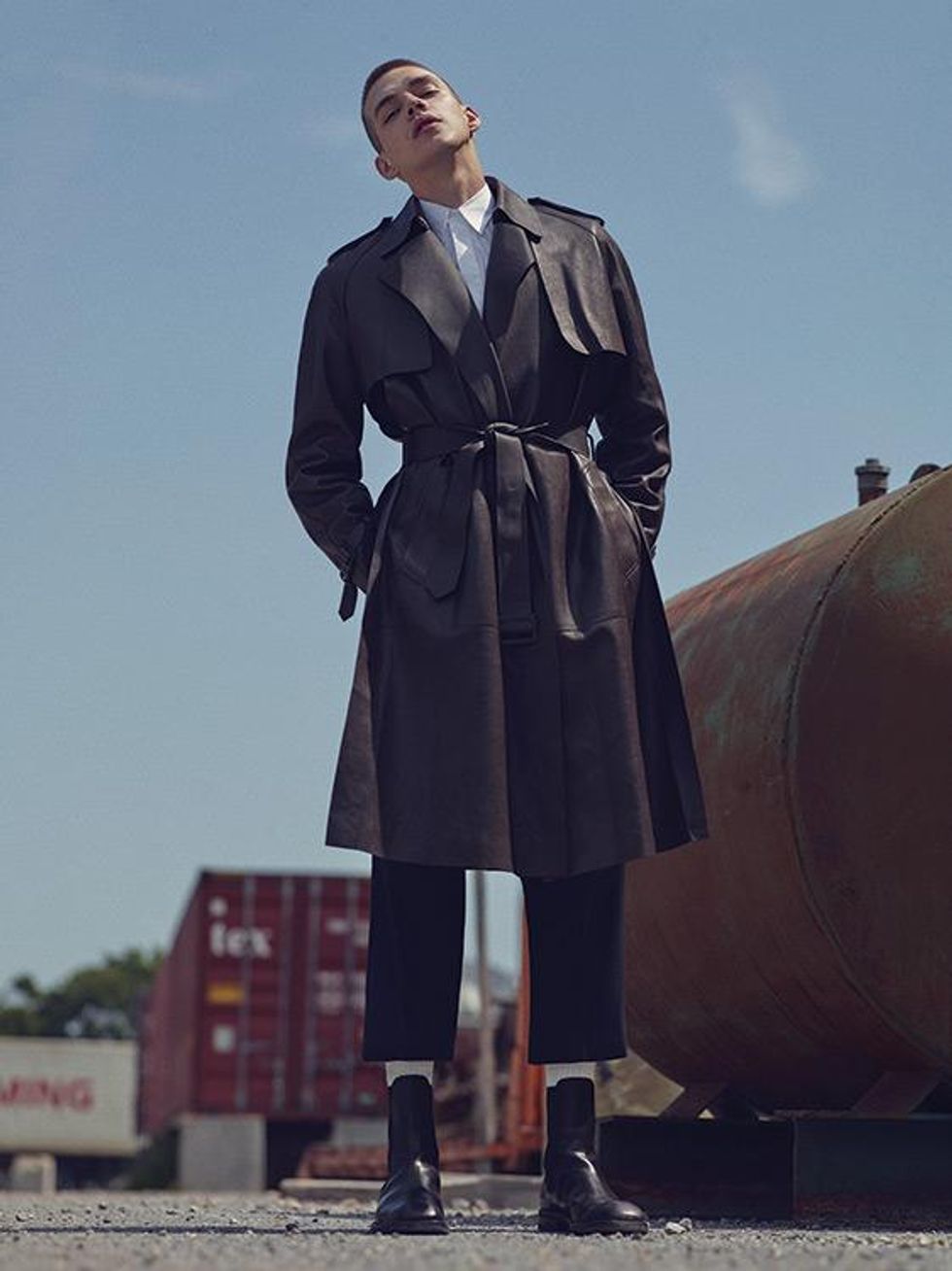 Coat, shirt, and pants by Louis Vuitton. Socks by Champion. Boots by Dries Van Noten.