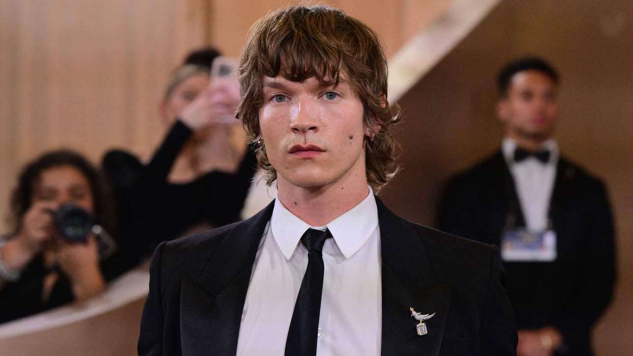 Connor Storrie in a suit on the red carpet at the Golden Globes