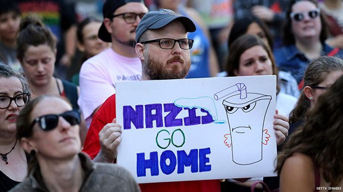 counter protester holding anti-nazi sign