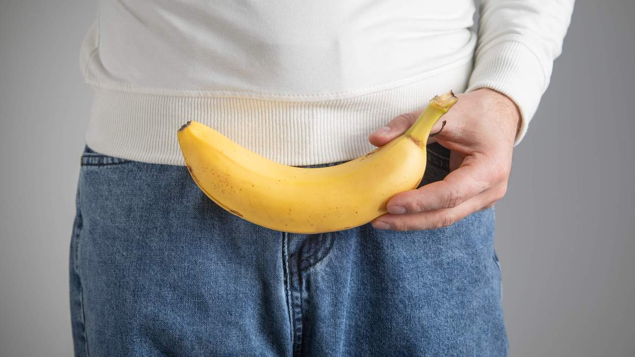 Cropped image of a man holding a banana