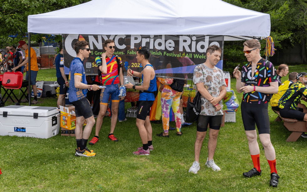 Cyclists gather near the NYC Pride Ride event tent