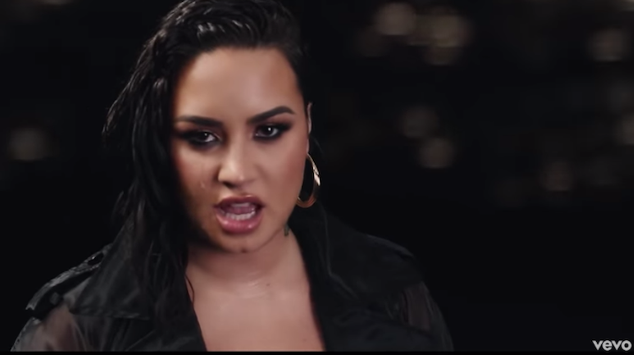 Demi Lovato with the word "VOTE" behind her