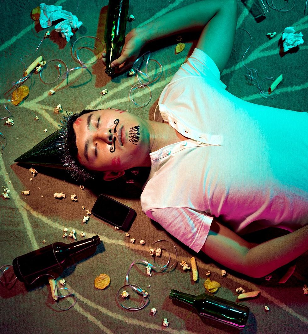 drunk guy asleep at party with marker on his face