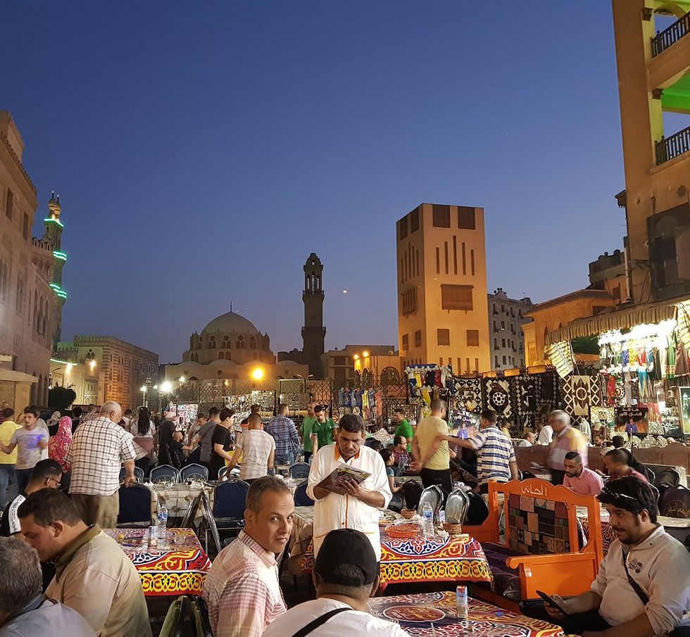 Egypt Cairo night market People are eating iftar to break the fast during Ramadan in Khan Khalili Market the most popular place for Ramadan activities in Cairo