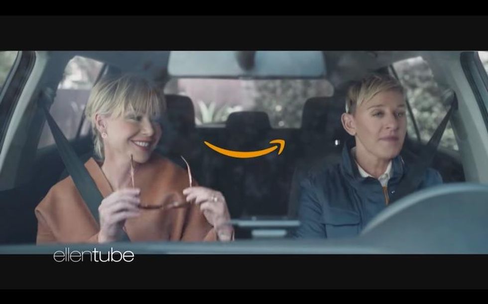 Ellen DeGeneres and Portia de Rossi sitting in a car.