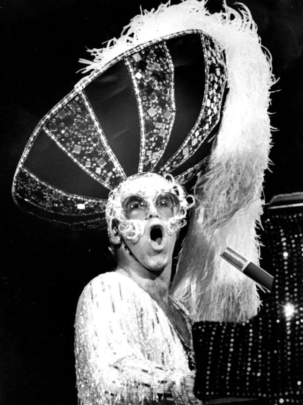 Elton John wears a giant, bejeweled sombrero.