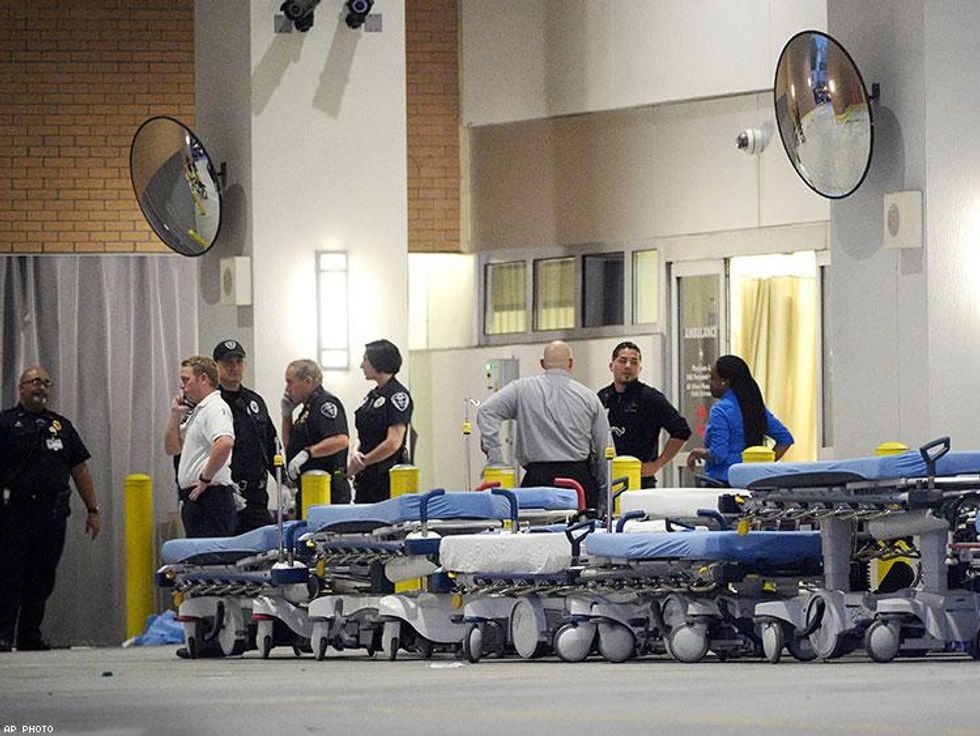 Emergency personnel wait with stretchers at the emergency entrance to Orlando Regional Medical Center hospital for the arrival of patients.