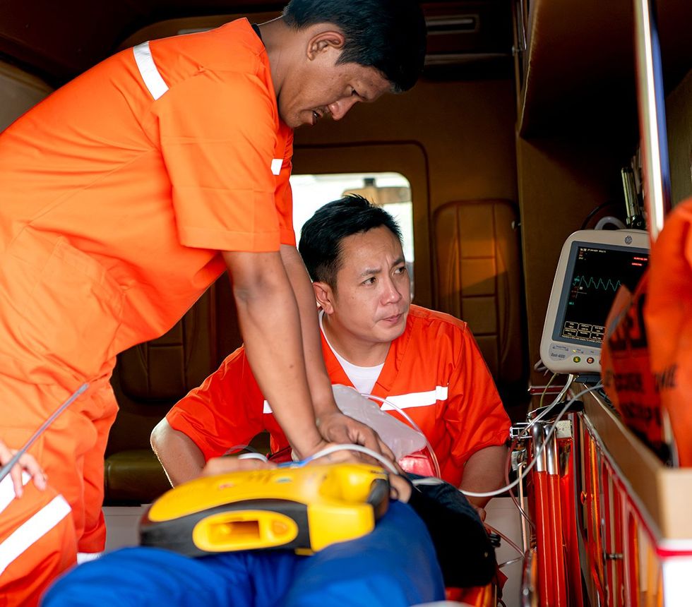 emergency response team administering life saving measures in an ambulance
