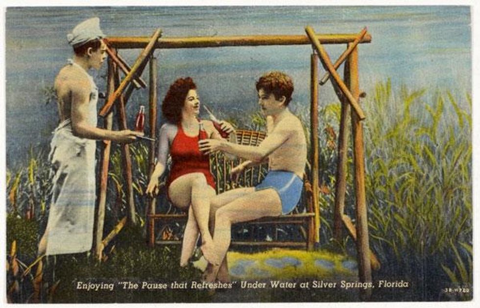 "Enjoying 'The Pause that Refreshes' under water at Silver Springs, Florida."