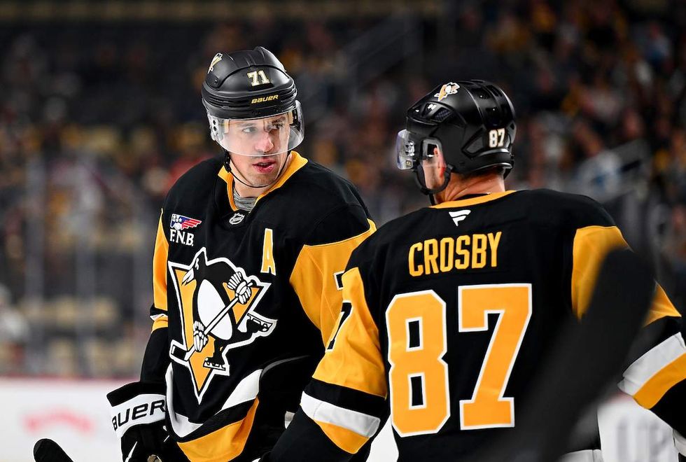 Evgeni Malkin #71 of the Pittsburgh Penguins and Sidney Crosby #87 of the Pittsburgh Penguins chat against the Vancouver Canucks