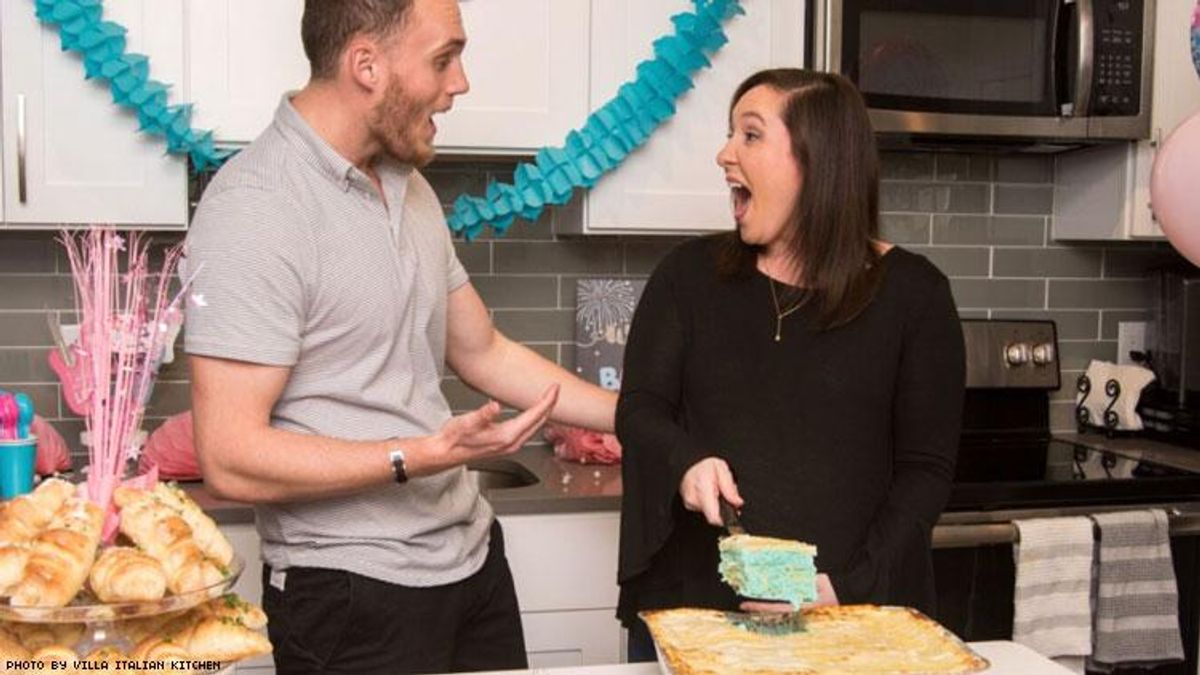 Expecting parents with their birth reveal lasagna