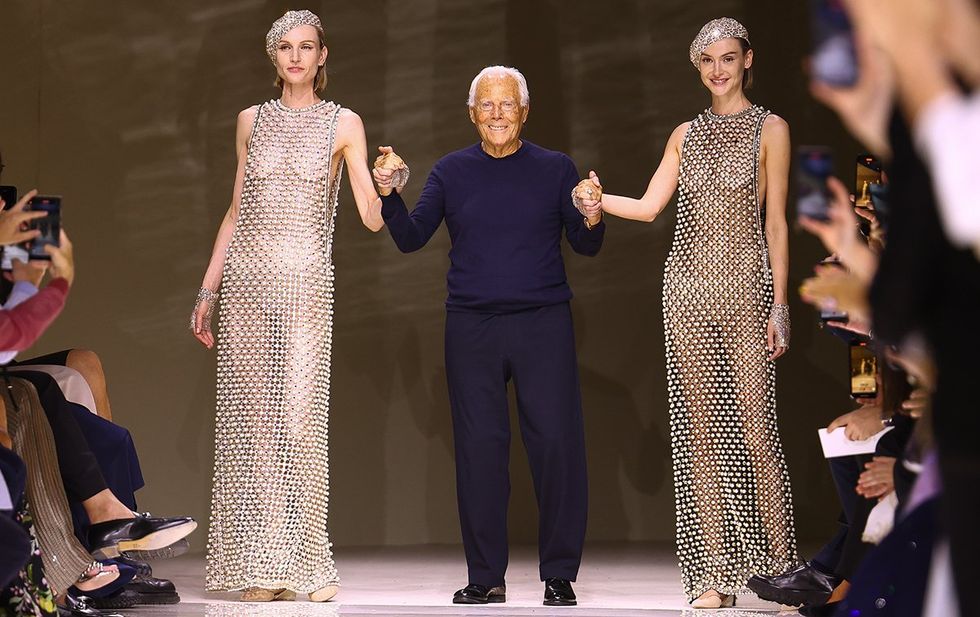 Fashion designer Giorgio Armani walks the runway with two models during Paris Fashion Week 2024