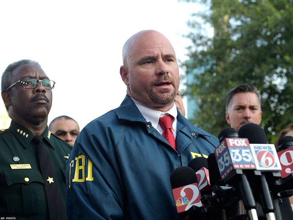 FBI assistant special agent in charge Ron Hopper, center, answers questions from members of the media after the fatal shooting.